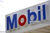 Mobil signage is displayed at a Mobil gas station in Chicago ...