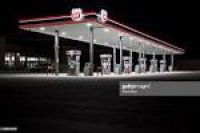 A Phillips 66 gas station stands illuminated at night in Princeton ...
